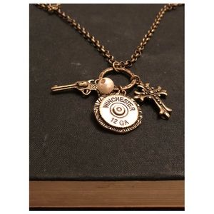 Aged gold necklace with gun and cross charm